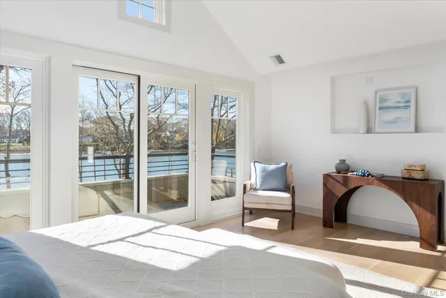 a bedroom with a bed and a large window