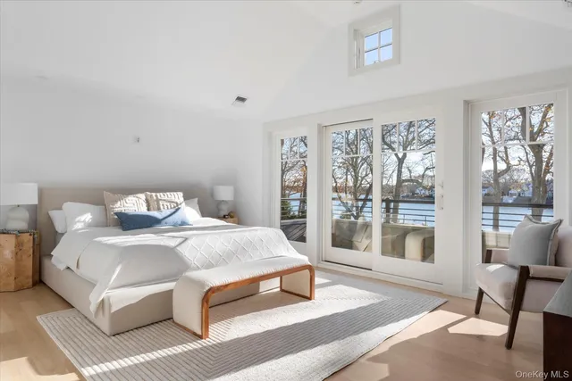 a bedroom with a large bed and a large window