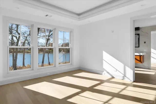 a view of a livingroom with wooden floor and furniture