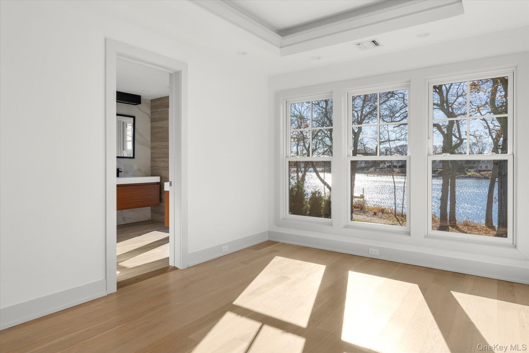 1750 Hobart Road Southold, NY 11971 - Photo 31 of 41 a view of an empty room with a window and wooden floor