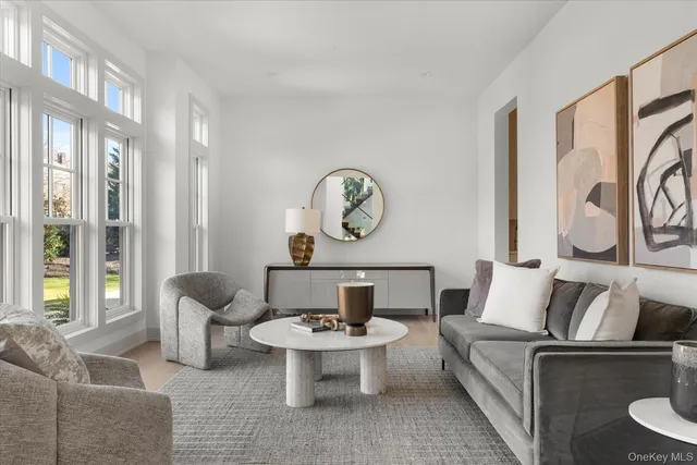 a living room with furniture a rug and a table