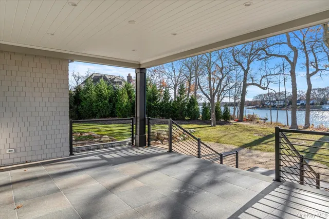 a view of a swimming pool with a patio and a yard