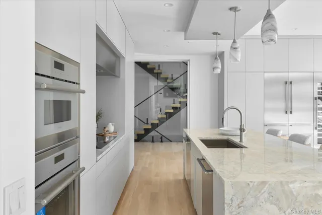 a kitchen with stainless steel appliances granite countertop a sink and dishwasher