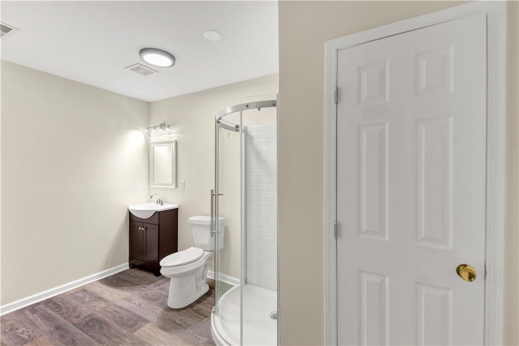 2880 Field Spring Drive Lithonia, GA 30058 - Photo 5 of 31 a bathroom with a toilet a sink and a shower