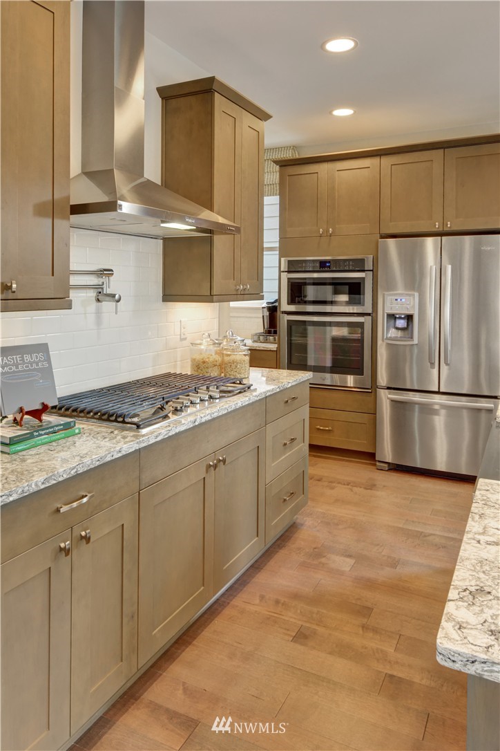 270 Field Place Southeast Renton, WA 98059 - Photo 5 of 20 a kitchen with granite countertop a sink and stainless steel appliances