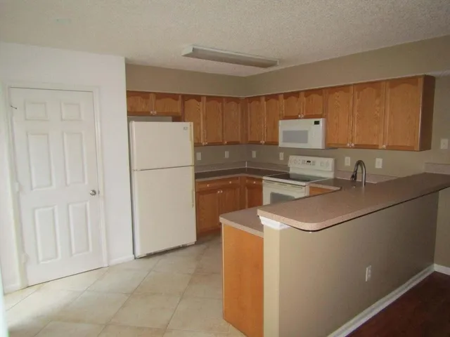 a kitchen with a sink a refrigerator and a stove