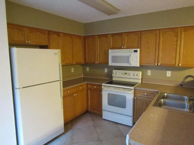 a white refrigerator freezer sitting in a kitchen