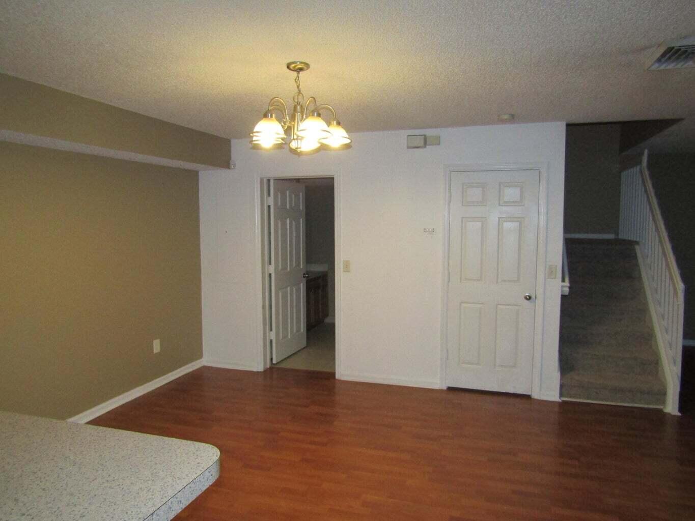 2212 White Pine Circle, Unit B Greenacres, FL 33415 - Photo 6 of 9 a view of a livingroom with a chandelier