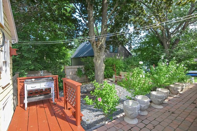 a view of a house with a yard porch and sitting area