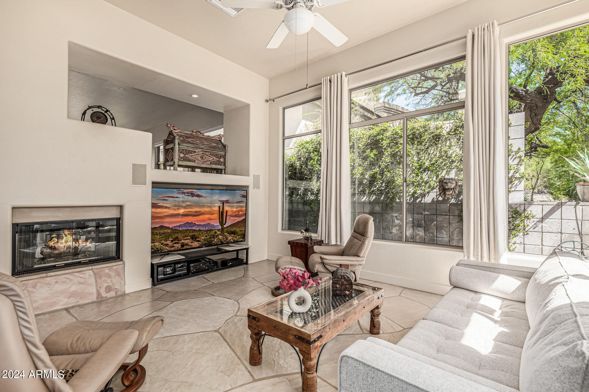 6437 North 28th Street Phoenix, AZ 85016 - Photo 12 of 53 a living room with furniture a flat screen tv and a fireplace
