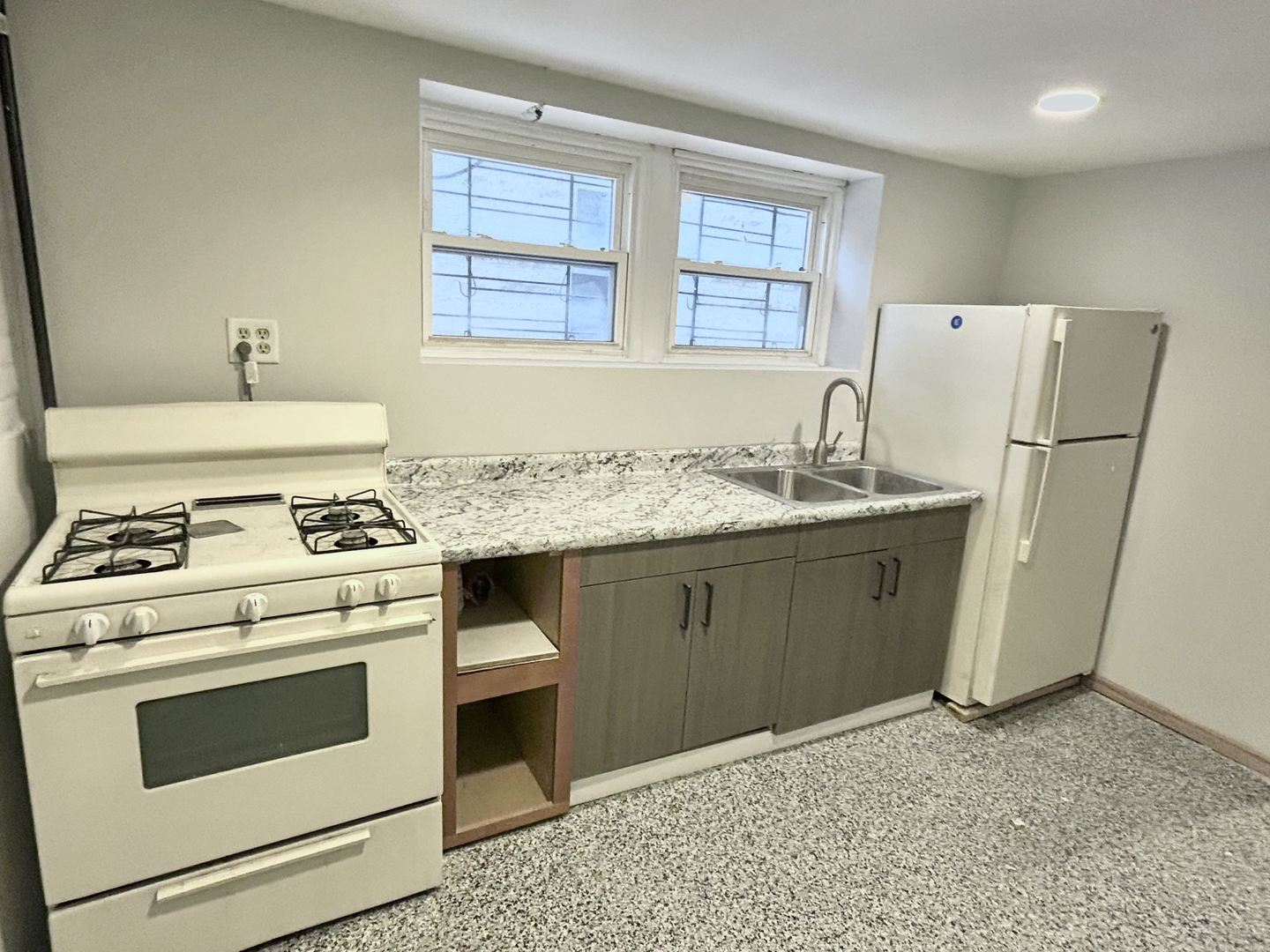 3056 West Lyndale Street, Unit G Chicago, IL 60647 - Photo 2 of 11 a kitchen with a stove a sink and a refrigerator