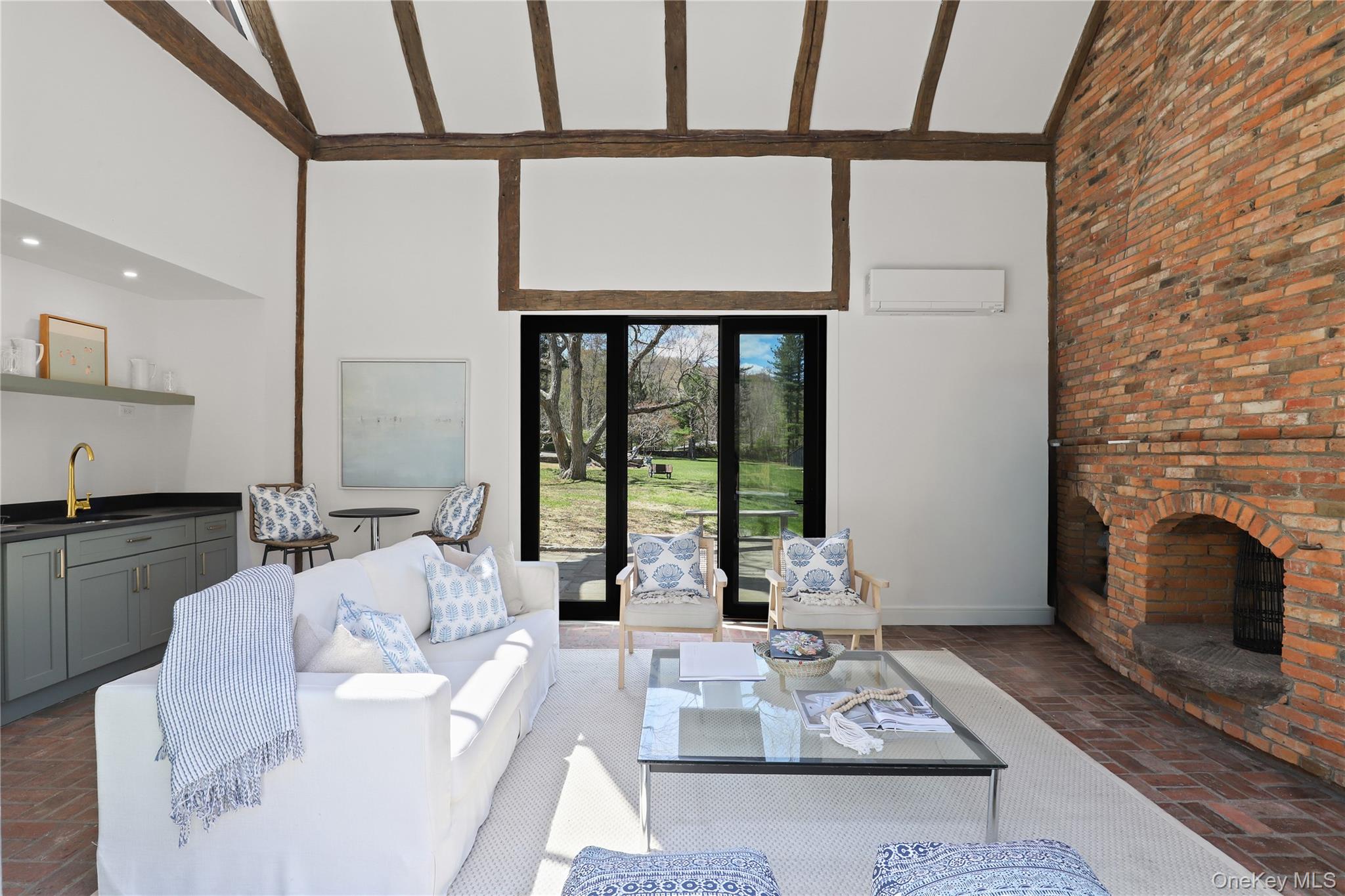 39 Old Snake Hill Road Pound Ridge, NY 10576 - Photo 23 of 37 a living room with furniture large window and a fireplace