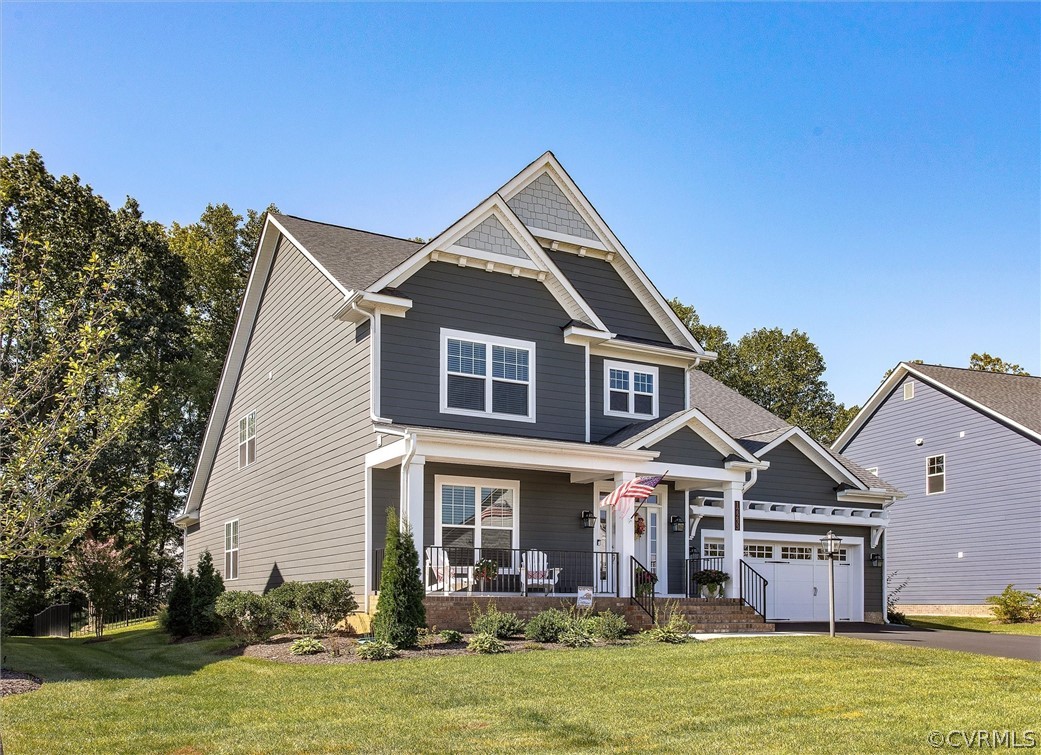 12233 Bremner Ridge Circle Manakin-Sabot, VA 23103 - Photo 2 of 49 a front view of house with yard and trees in the background