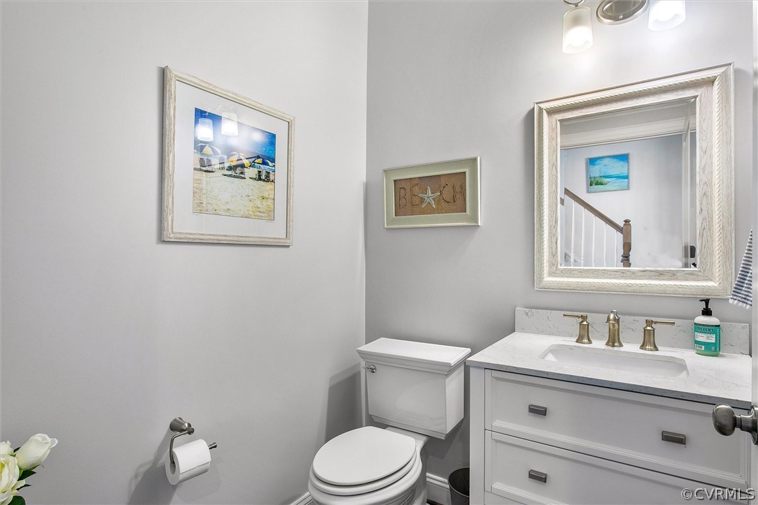 12233 Bremner Ridge Circle Manakin-Sabot, VA 23103 - Photo 24 of 49 a bathroom with a toilet sink vanity and mirror