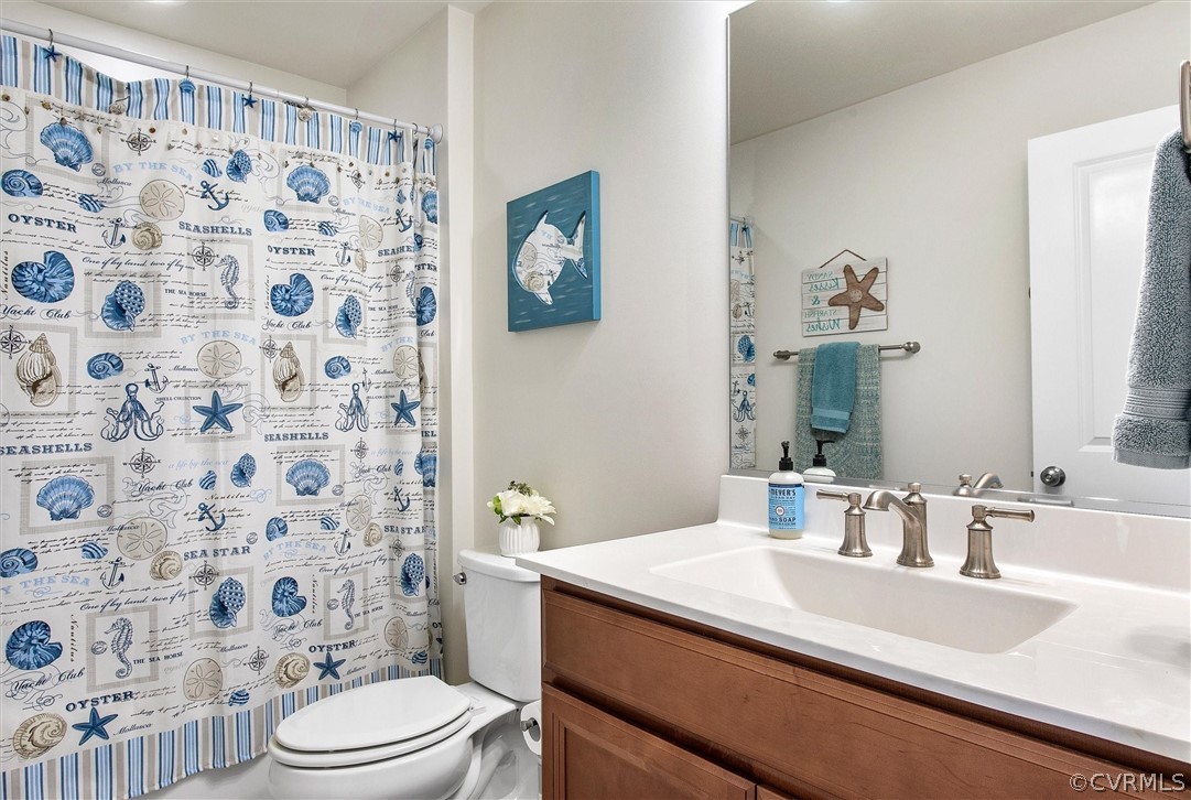 12233 Bremner Ridge Circle Manakin-Sabot, VA 23103 - Photo 34 of 49 a bathroom with a sink a toilet and shower curtain