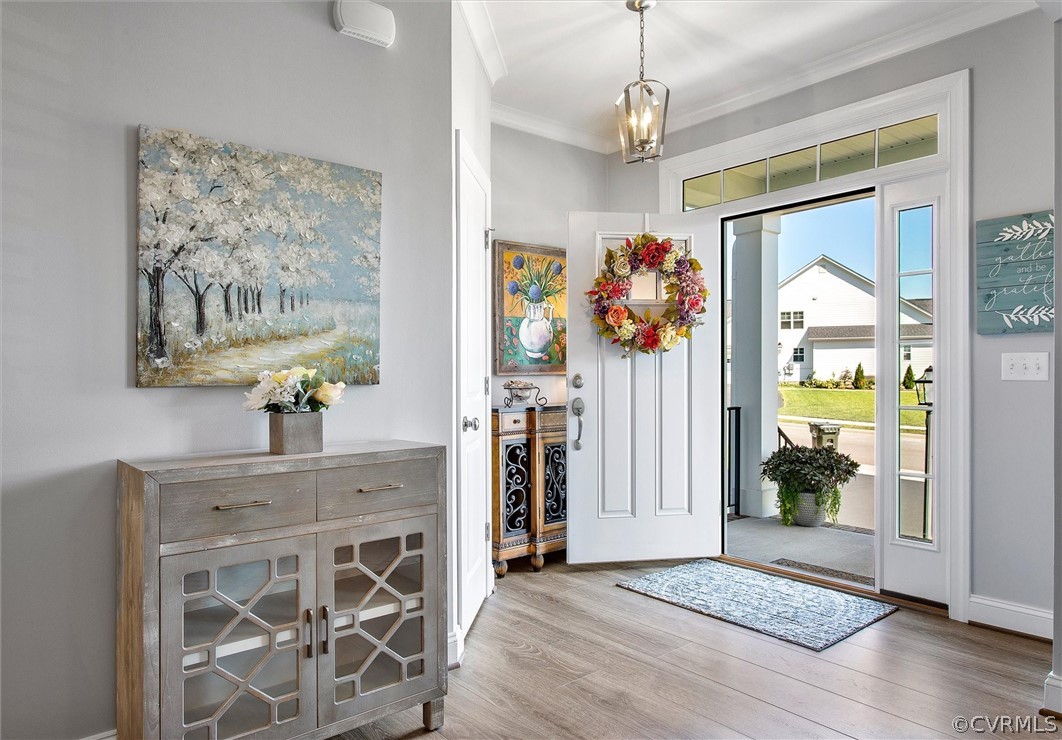 12233 Bremner Ridge Circle Manakin-Sabot, VA 23103 - Photo 6 of 49 a view of a hallway with wooden floor and a chandelier