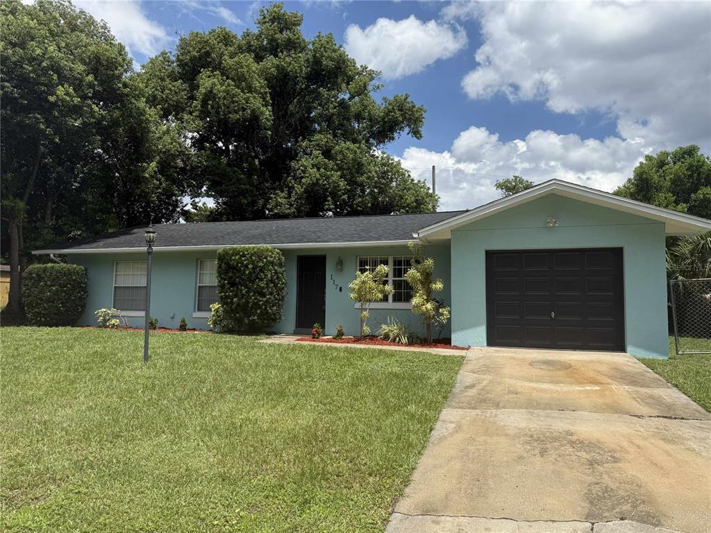 a front view of a house with a yard and garage