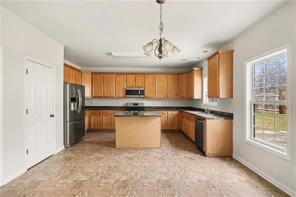 a large white kitchen with a large window