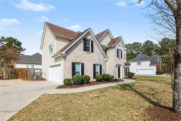 a front view of a house with garden
