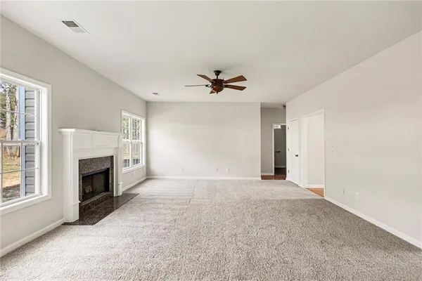 a view of a livingroom with a fireplace and window