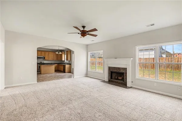 an empty room with furniture and a fireplace