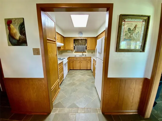 a kitchen with stainless steel appliances a refrigerator and a stove