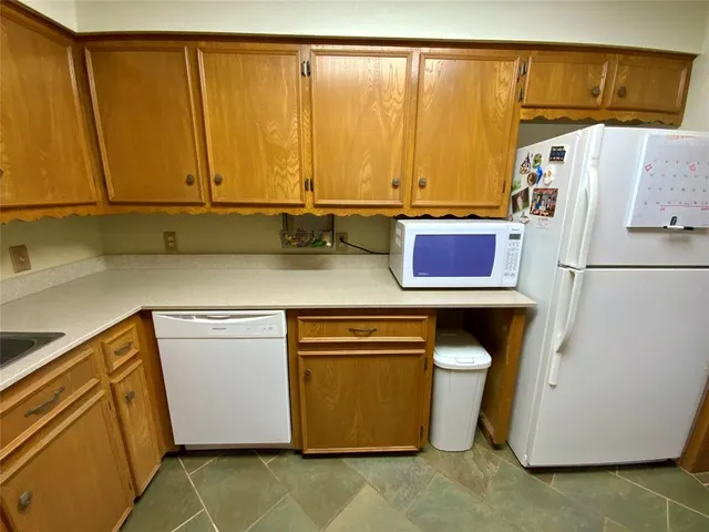 a kitchen with a refrigerator and cabinets