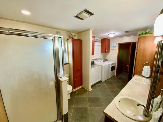 a bathroom with a sink toilet and shower