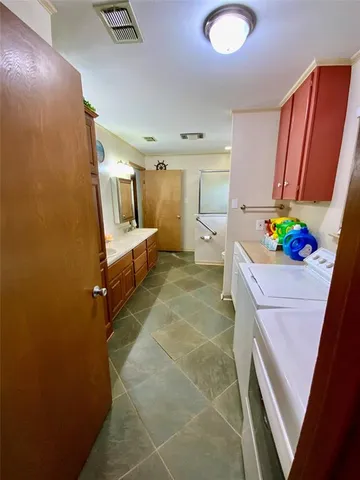 a bathroom with a sink mirror vanity and toilet