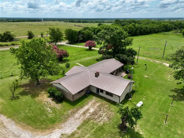 a view of a house with a yard and a pool