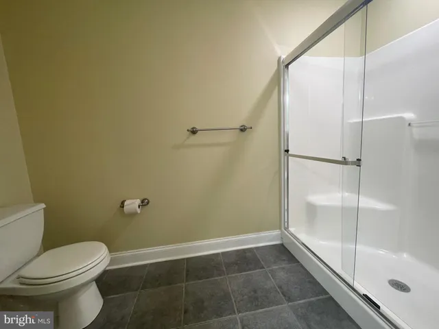 a bathroom with a glass shower door