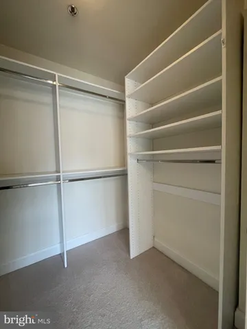 a bathroom with a sink a toilet a large mirror and shower