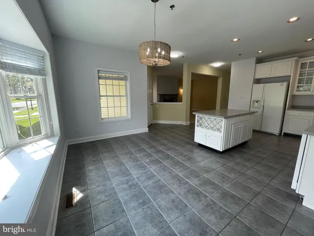 a view of an empty room with a fireplace and a window
