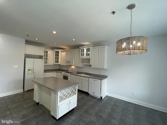 a kitchen with stainless steel appliances granite countertop a sink and a stove