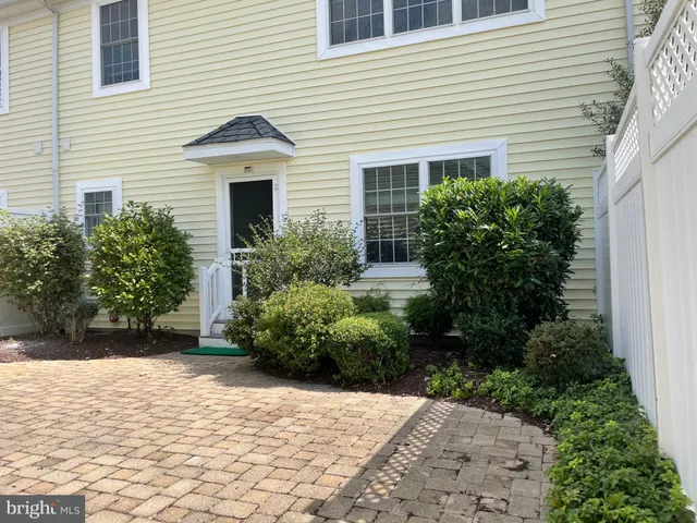 a view of a house with potted plants