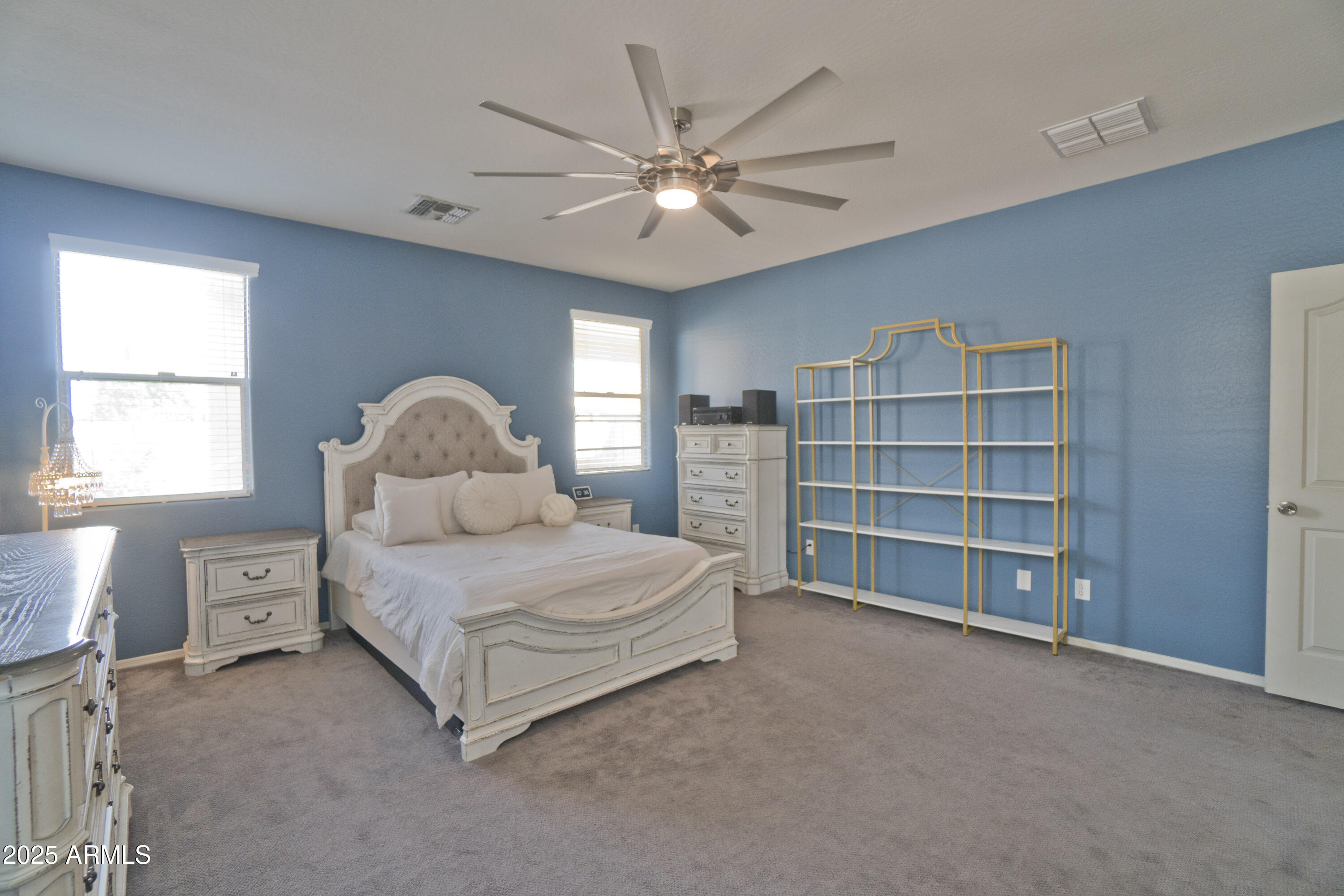 3412 West Apollo Road Phoenix, AZ 85041 - Photo 21 of 39 a bedroom with a large bed and a chandelier