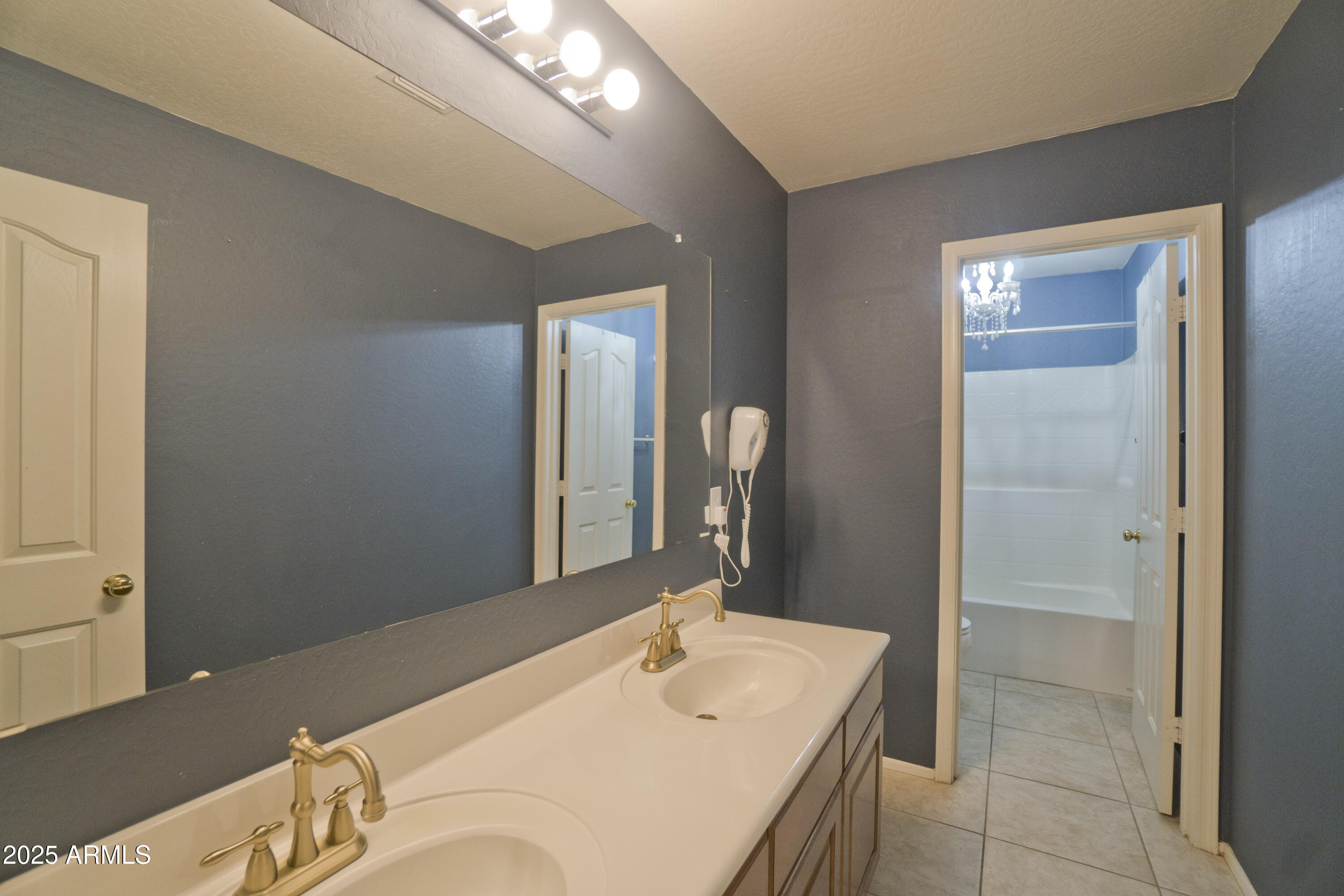 3412 West Apollo Road Phoenix, AZ 85041 - Photo 30 of 39 a bathroom with a sink and a mirror