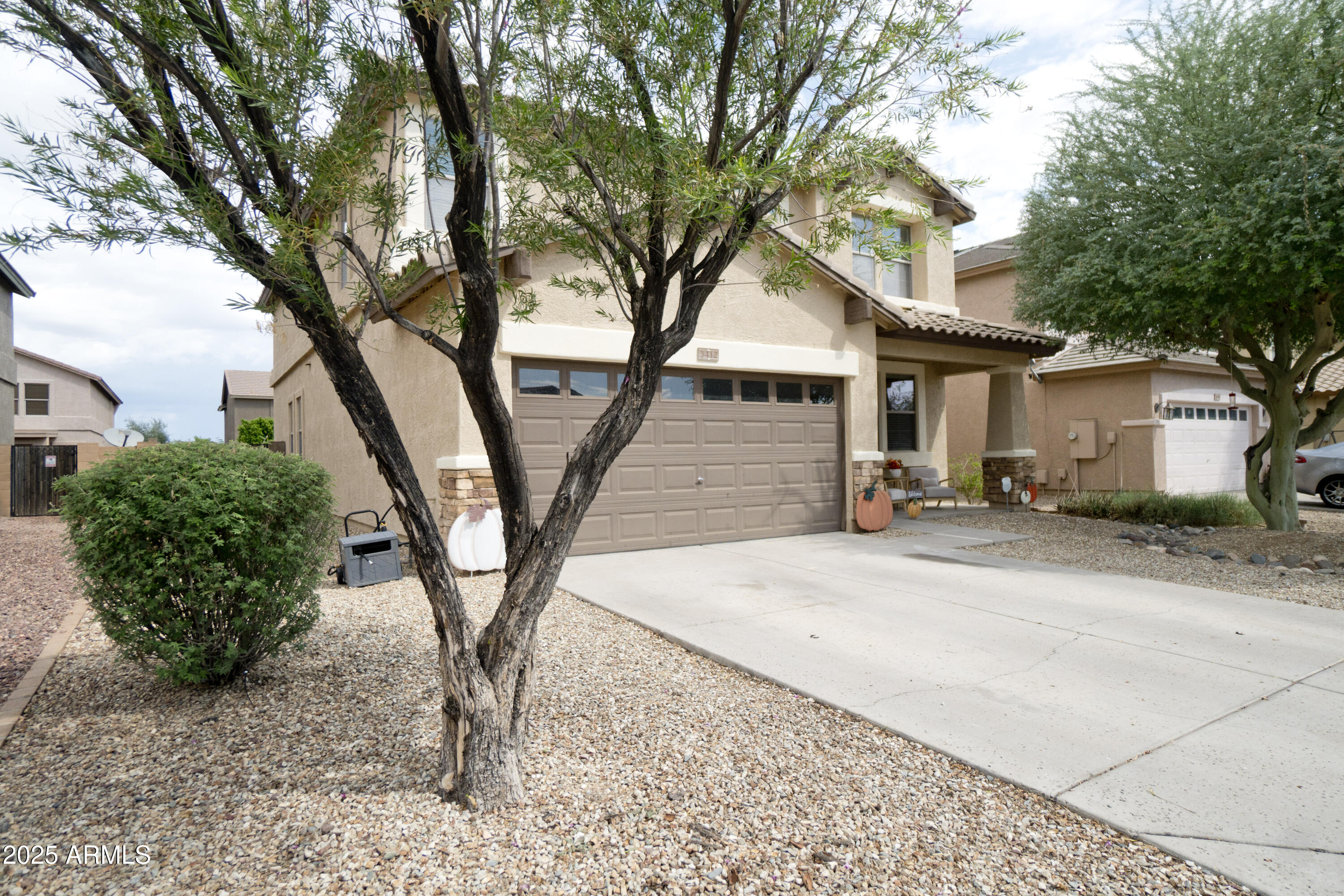 3412 West Apollo Road Phoenix, AZ 85041 - Photo 3 of 39 a tree in front of a white house