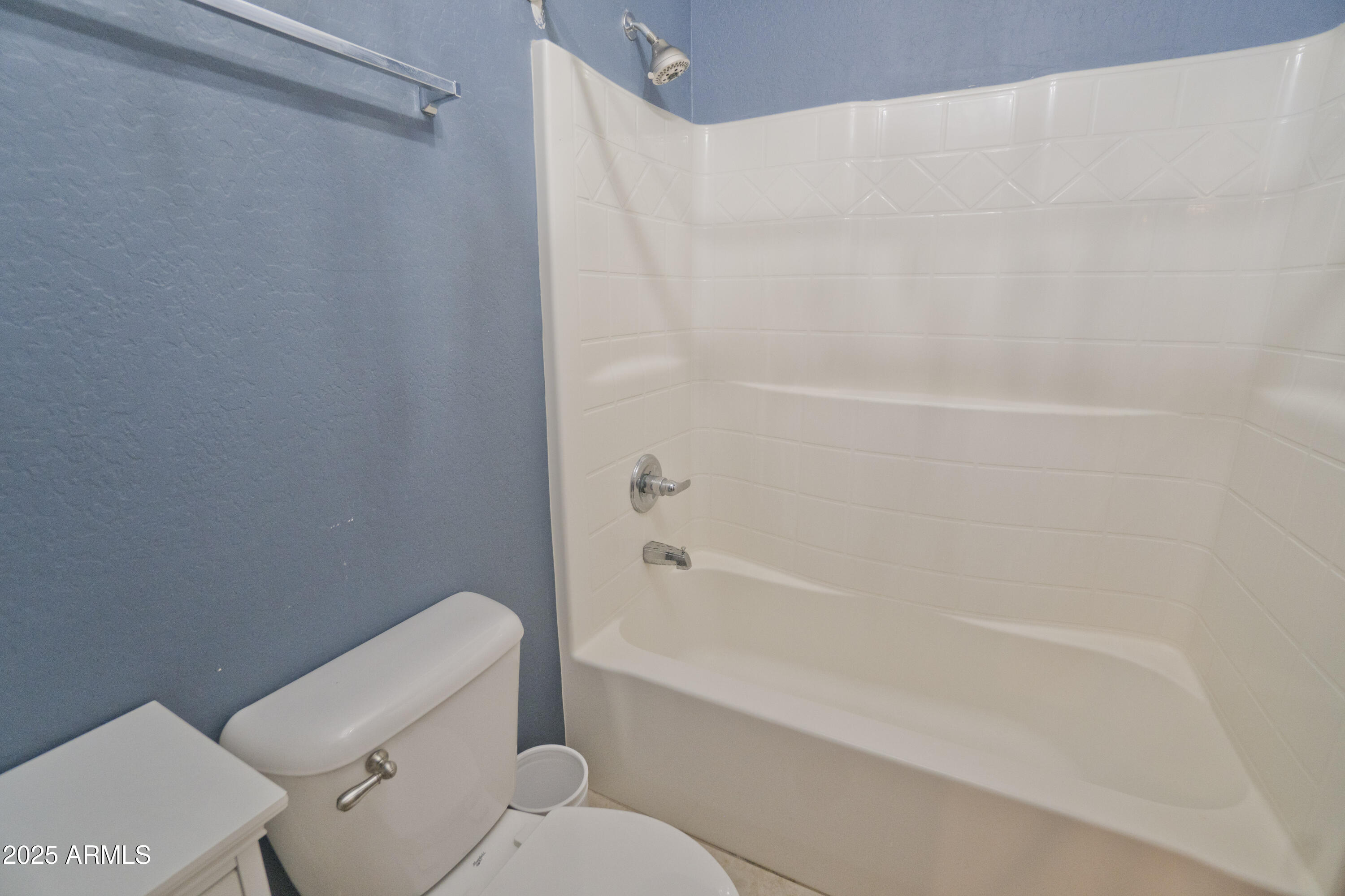 3412 West Apollo Road Phoenix, AZ 85041 - Photo 31 of 39 a bathroom with a toilet and a bathtub