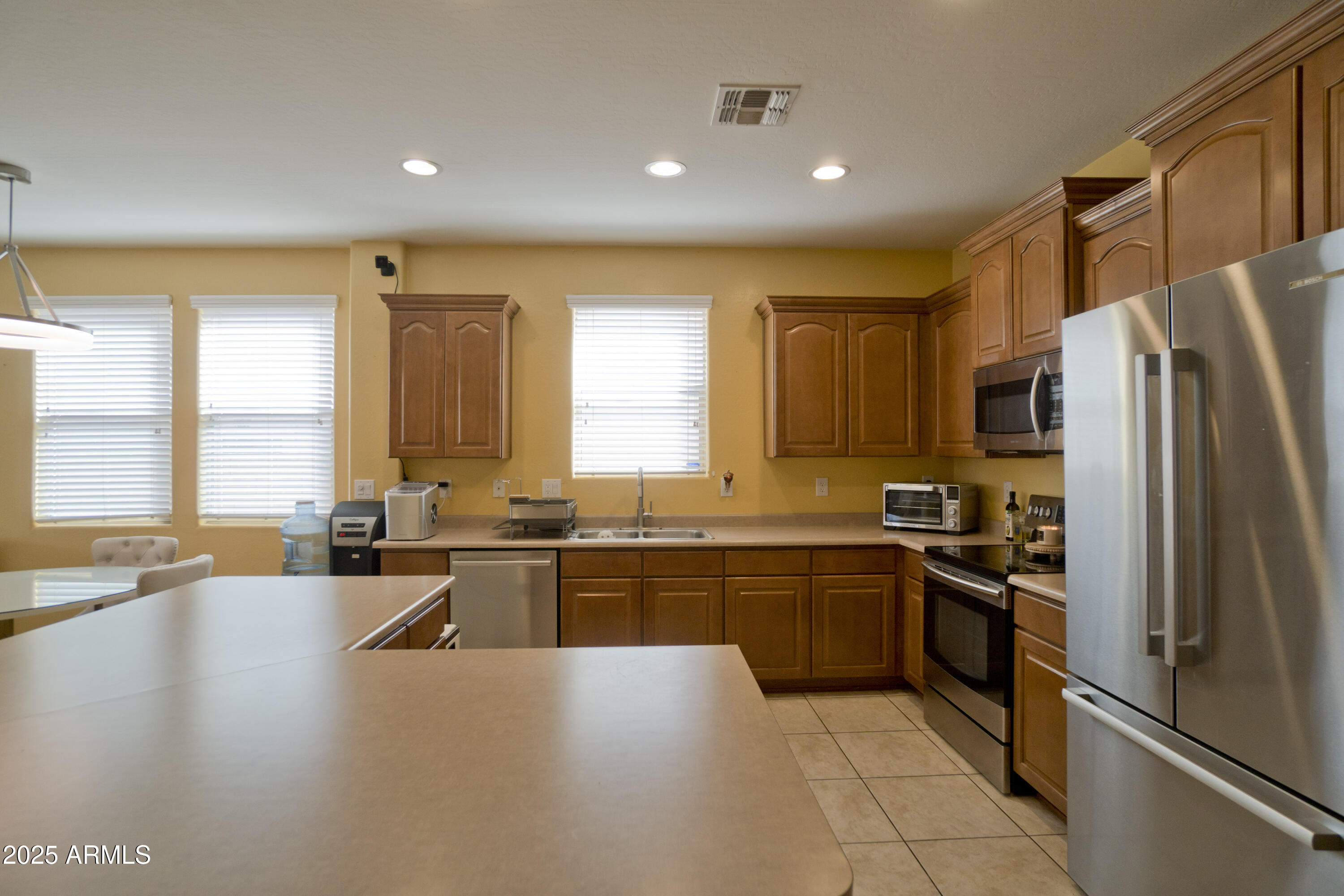 3412 West Apollo Road Phoenix, AZ 85041 - Photo 10 of 39 a large kitchen with a large window and stainless steel appliances