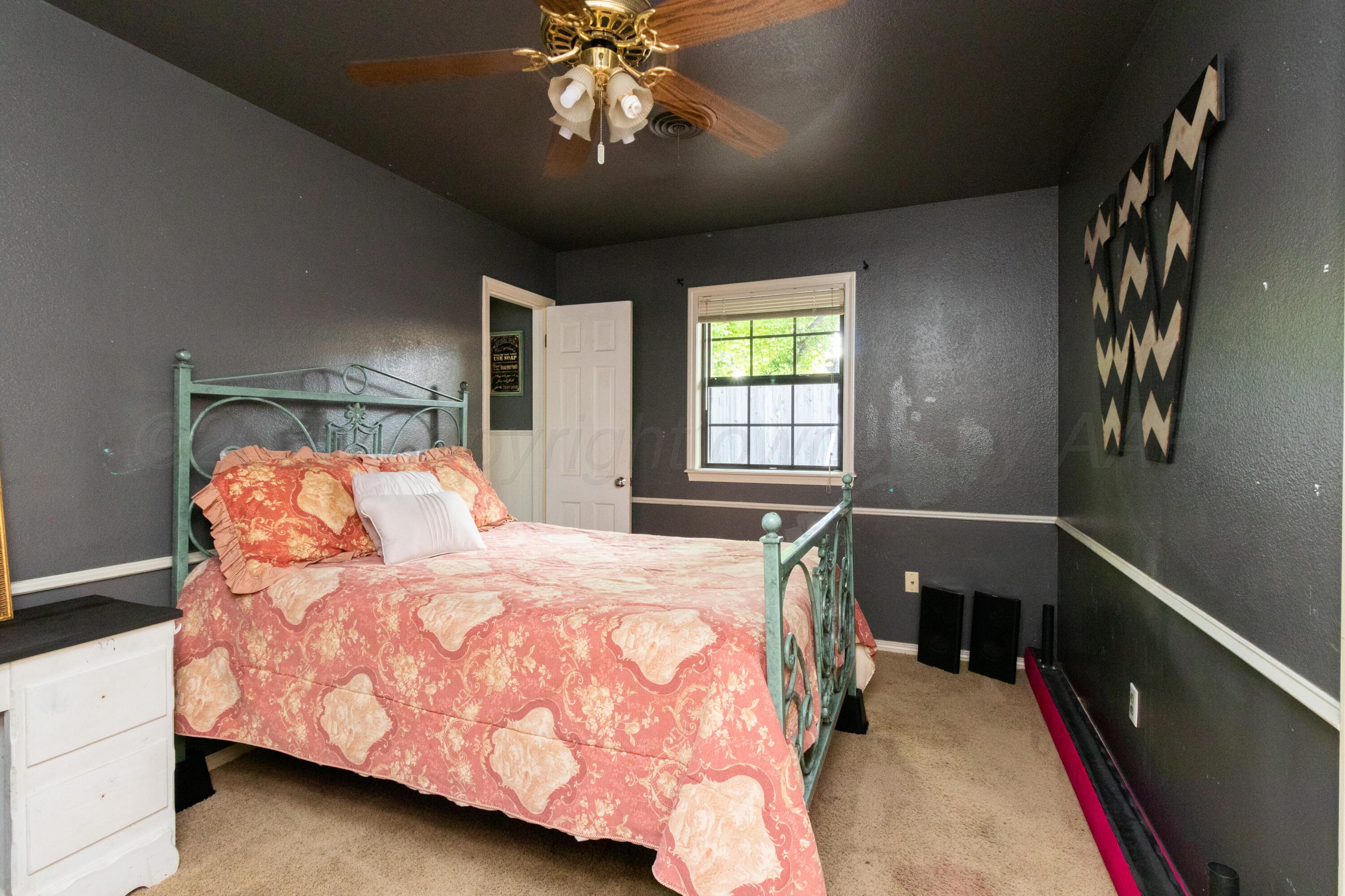 7104 Dreyfuss Road Amarillo, TX 79106 - Photo 23 of 43 a bedroom with a bed and window
