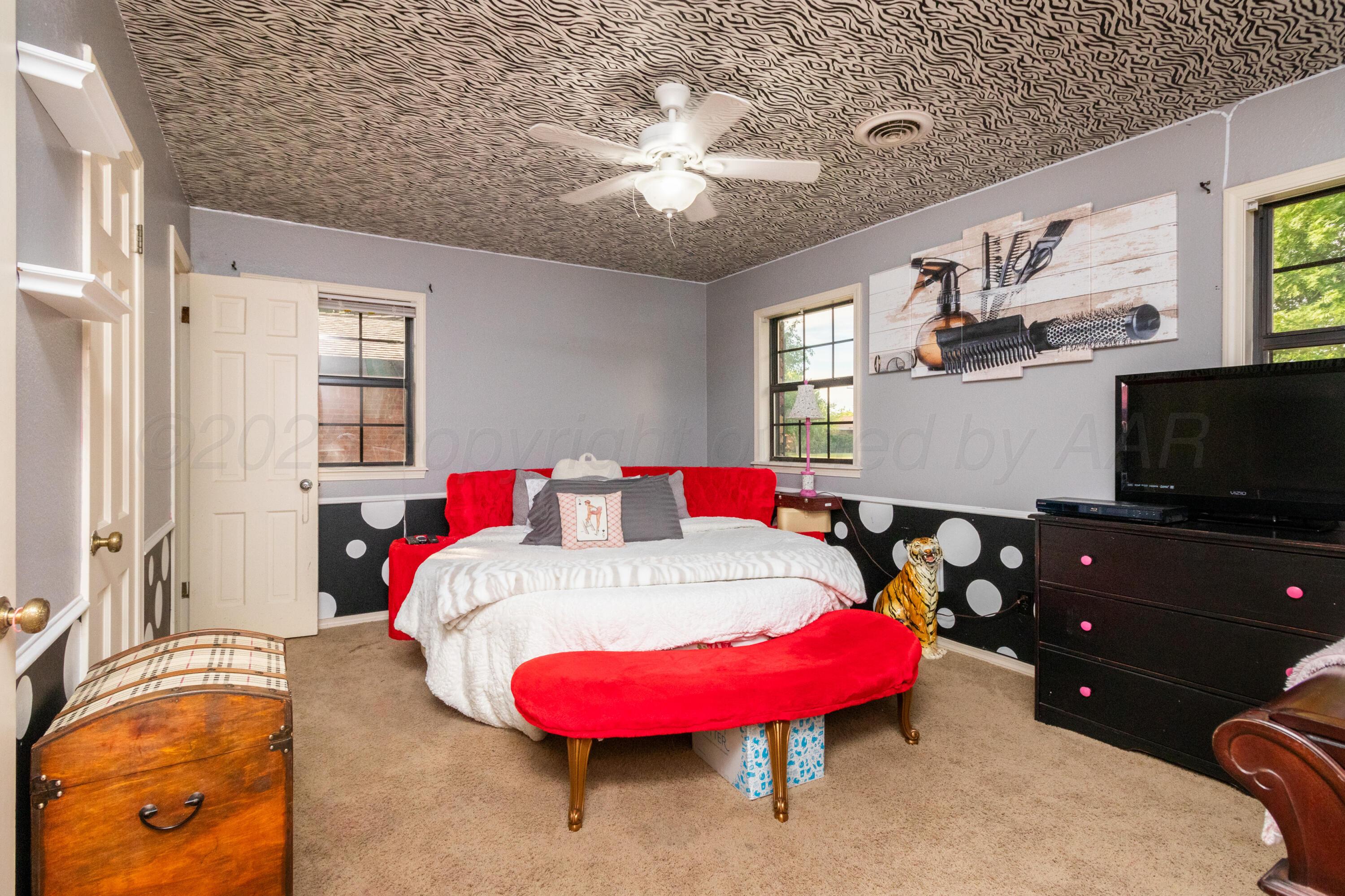 7104 Dreyfuss Road Amarillo, TX 79106 - Photo 25 of 43 a bedroom with a bed and a flat screen tv