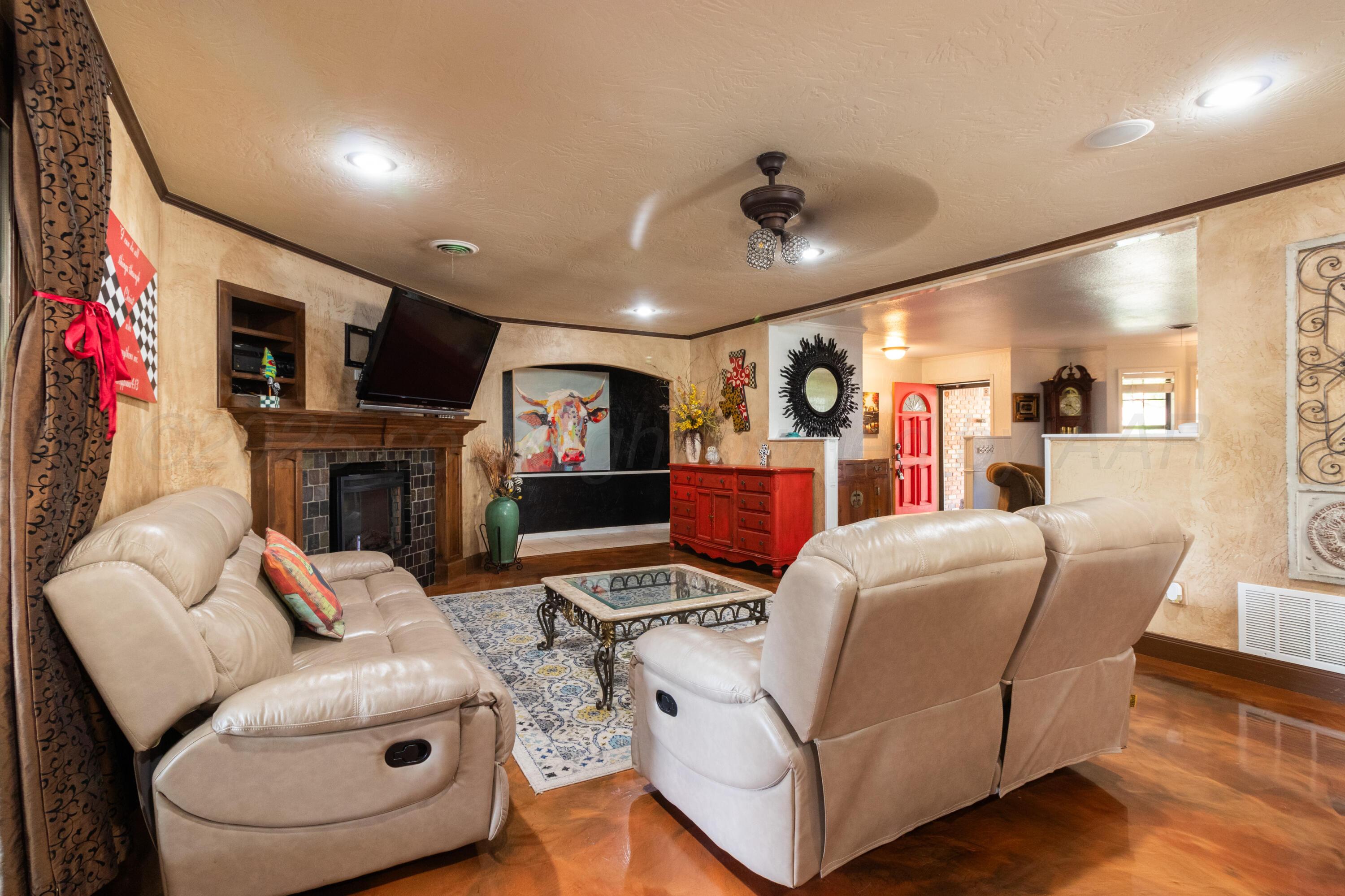 7104 Dreyfuss Road Amarillo, TX 79106 - Photo 7 of 43 a living room with fireplace furniture and a flat screen tv