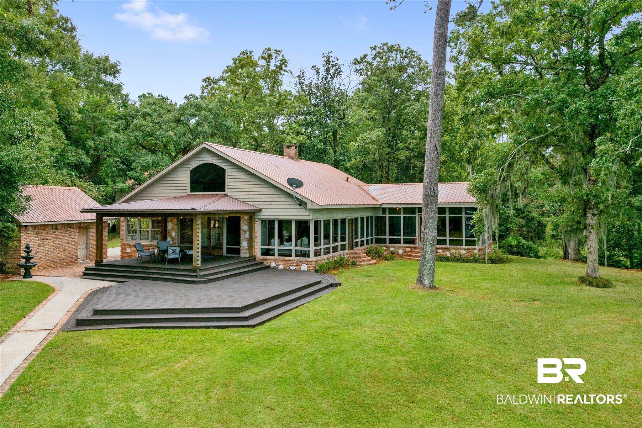 2228 Riverside Drive Mobile, AL 36605 - Photo 34 of 51 View of front facade with a sunroom, a deck, and a front lawn