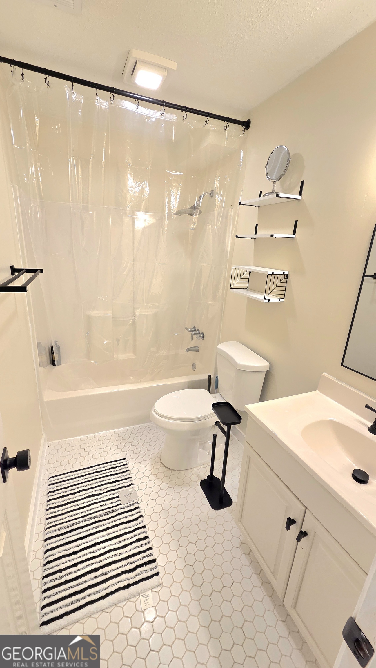 3435 Alexander Place Southwest Smyrna, GA 30082 - Photo 11 of 14 a bathroom with a sink toilet a shower and a bathtub