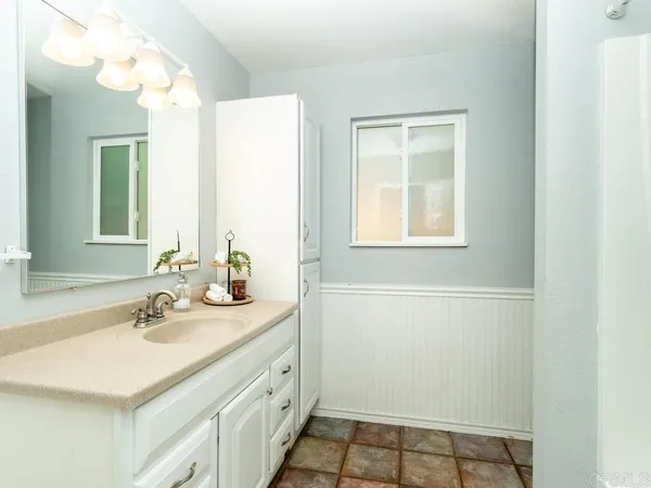 a bathroom with a sink a vanity and a mirror