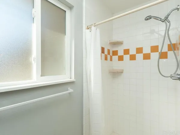 a bathroom with a shower and a mirror