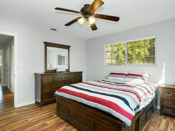 a bedroom with a bed and a dresser