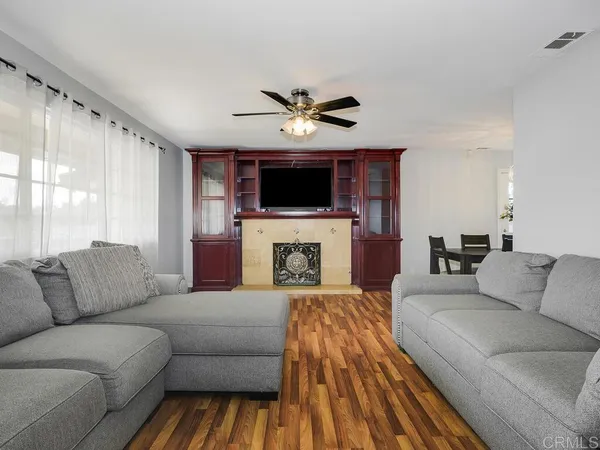 a living room with furniture a fireplace and a flat screen tv