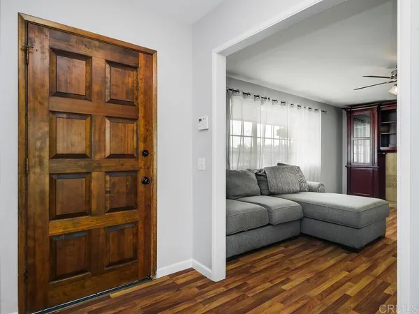 a living room with furniture closet and window